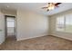 Bedroom with neutral walls, carpet flooring, and natural light from window with white shutters at 3615 Dutchmans Vine Ct, North Las Vegas, NV 89081