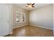 Cozy bedroom with neutral walls, tile flooring, ceiling fan, and natural light at 3615 Dutchmans Vine Ct, North Las Vegas, NV 89081