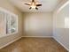 Neutral bedroom featuring tile floors, a ceiling fan and natural light from the window at 3615 Dutchmans Vine Ct, North Las Vegas, NV 89081