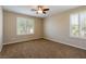 Bedroom with neutral walls, carpet flooring, and windows with white shutters at 3615 Dutchmans Vine Ct, North Las Vegas, NV 89081