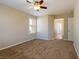 Bedroom with neutral walls, carpet flooring, ceiling fan, and window with white shutters at 3615 Dutchmans Vine Ct, North Las Vegas, NV 89081