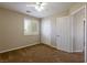 Cozy bedroom with plush carpet, ceiling fan, window with shutters, and closet for optimal functionality at 3615 Dutchmans Vine Ct, North Las Vegas, NV 89081