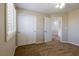 Bedroom featuring plush carpeting, ceiling fan, and white doors leading to additional rooms at 3615 Dutchmans Vine Ct, North Las Vegas, NV 89081