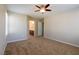 Bedroom with neutral walls, carpet flooring, ceiling fan, and ensuite access at 3615 Dutchmans Vine Ct, North Las Vegas, NV 89081