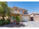 Inviting two-story home featuring a well-manicured yard and a convenient two-car garage at 3615 Dutchmans Vine Ct, North Las Vegas, NV 89081