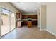 Open kitchen featuring wood cabinets, tile floors, stainless appliances and outdoor access at 3615 Dutchmans Vine Ct, North Las Vegas, NV 89081