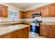 Well-lit kitchen featuring granite countertops, a center island, and stainless steel appliances at 3615 Dutchmans Vine Ct, North Las Vegas, NV 89081