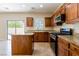 Well-lit kitchen features granite countertops, dark wood cabinets, island, and stainless steel appliances at 3615 Dutchmans Vine Ct, North Las Vegas, NV 89081