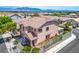 Back aerial view of fenced home with tile roof, desert landscaping, and mountain views at 3954 Crystal Trip Ct, Las Vegas, NV 89129