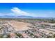 Expansive aerial view of residential community with mountains in the distance at 3954 Crystal Trip Ct, Las Vegas, NV 89129
