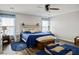 Cozy bedroom with wood floors, ceiling fan, and rustic wood headboard with blue accents at 3954 Crystal Trip Ct, Las Vegas, NV 89129