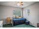 Bright bedroom with a daybed, blue accents, ceiling fan, and natural light from the windows at 3954 Crystal Trip Ct, Las Vegas, NV 89129