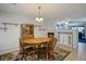 Formal dining room featuring a wooden table and chairs, with views into the living room and fireplace at 3954 Crystal Trip Ct, Las Vegas, NV 89129