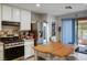 Bright kitchen features white cabinets, stainless steel appliances, and a cozy eat-in island with butcher block top at 3954 Crystal Trip Ct, Las Vegas, NV 89129