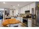 Bright kitchen features white cabinets, stainless steel appliances, and a cozy eat-in island with butcher block top at 3954 Crystal Trip Ct, Las Vegas, NV 89129