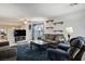 Spacious living room featuring a plush blue rug, modern shelving, and comfortable seating at 3954 Crystal Trip Ct, Las Vegas, NV 89129