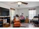 Cozy living room featuring hardwood floors, ceiling fan, and window with natural light at 3954 Crystal Trip Ct, Las Vegas, NV 89129