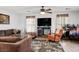 Comfortable living room with a brown sofa set and a TV setup, enhanced by a floral rug at 3954 Crystal Trip Ct, Las Vegas, NV 89129