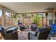 Enclosed sunroom with comfortable wicker seating and views of the backyard at 3954 Crystal Trip Ct, Las Vegas, NV 89129