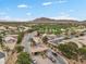 Beautiful aerial view of a guard-gated community with lush landscaping, mountains, and well-maintained homes at 4062 Vulcan St, Las Vegas, NV 89122
