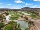 Picturesque aerial view of the golf course featuring lush greens, lakes, and trees creating a serene environment at 4062 Vulcan St, Las Vegas, NV 89122
