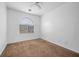 Cozy bedroom with neutral carpet, large window, and ample natural light at 4062 Vulcan St, Las Vegas, NV 89122