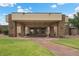 Impressive entrance to the clubhouse with stone columns, portico, and well-maintained landscaping creating welcoming curb appeal at 4062 Vulcan St, Las Vegas, NV 89122