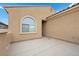 Front entrance with neutral-colored exterior and well-maintained concrete patio at 4062 Vulcan St, Las Vegas, NV 89122