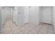 Bright hallway featuring tile flooring, recessed lighting, and access to various rooms in the house at 4062 Vulcan St, Las Vegas, NV 89122