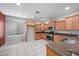 Bright kitchen with tile flooring, wood cabinets, stainless steel appliances, and granite countertops at 4062 Vulcan St, Las Vegas, NV 89122
