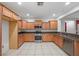 Well-lit kitchen featuring wooden cabinets, stainless steel appliances and granite countertops at 4062 Vulcan St, Las Vegas, NV 89122