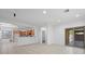 Open-concept living room and kitchen area with tile flooring and natural light at 4062 Vulcan St, Las Vegas, NV 89122