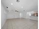 Expansive living room with tile flooring, recessed lights, and seamless flow to the kitchen at 4062 Vulcan St, Las Vegas, NV 89122