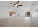 Open-concept living area with tile floors and access to kitchen and backyard at 4062 Vulcan St, Las Vegas, NV 89122