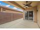 Covered back patio with sliding glass doors and a ceiling fan, perfect for outdoor relaxation at 4062 Vulcan St, Las Vegas, NV 89122