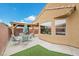 An outdoor patio featuring a gazebo, table, chairs, and vibrant blue accents, perfect for outdoor entertaining at 4062 Vulcan St, Las Vegas, NV 89122