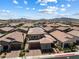 Aerial view of houses that shows community mountain views, and mature landscaping at 417 Honeybrush Ave, Henderson, NV 89011