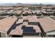 An aerial view of a home with solar panels in a vibrant community setting with mountain views at 417 Honeybrush Ave, Henderson, NV 89011
