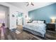 This bedroom boasts wood-look flooring, a ceiling fan, and an adjacent ensuite bathroom, creating a private retreat at 417 Honeybrush Ave, Henderson, NV 89011