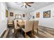 Dining area featuring a wooden table, upholstered chairs, and wood-look floors with lots of light at 417 Honeybrush Ave, Henderson, NV 89011