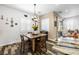 Cozy dining area featuring a wooden table, shuttered windows, and hardwood style floors at 417 Honeybrush Ave, Henderson, NV 89011