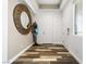 Bright entryway featuring wood-look floors, a stylish mirror, and a coat rack for convenient storage at 417 Honeybrush Ave, Henderson, NV 89011