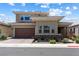 Two-story home boasting desert landscaping, a brick-paved driveway, and a two-car garage at 417 Honeybrush Ave, Henderson, NV 89011