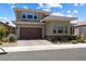 Beautiful two-story home boasting desert landscaping, a brick-paved driveway, and a two-car garage at 417 Honeybrush Ave, Henderson, NV 89011