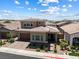 Two-story home boasting desert landscaping, a brick-paved driveway, and a two-car garage at 417 Honeybrush Ave, Henderson, NV 89011