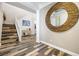 Inviting foyer with wood-look tile floors, staircase, and decorative mirror at 417 Honeybrush Ave, Henderson, NV 89011