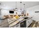 Open concept kitchen with granite countertops, stainless steel appliances and island seating at 417 Honeybrush Ave, Henderson, NV 89011