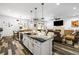 Stylish kitchen featuring a large island with seating, modern lighting and stainless appliances at 417 Honeybrush Ave, Henderson, NV 89011