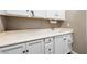Bright laundry room features ample cabinetry, a sink, and a countertop work surface, perfect for organizing household chores at 417 Honeybrush Ave, Henderson, NV 89011