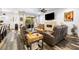 Comfortable living room featuring a stone fireplace, wood-look floors, and cozy seating arrangements at 417 Honeybrush Ave, Henderson, NV 89011
